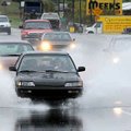 While the area was still under a flash-flood warning, motorists plowed through runoff water during m...