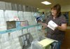Sheryl Davis, Collier Drug Store greeting card merchant, inventories ruined greeting cards Friday morning after rain waters leaked through the Dickson Street store’s ceiling Thursday night. Thousands of cards were damaged during the thunderstorms Thursday night. 

