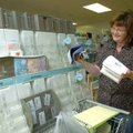 Sheryl Davis, Collier Drug Store greeting card merchant, inventories ruined greeting cards Friday mo...