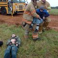 Emergency responders Blake Webb (center) from the Highfill Fire Department and Dusty Meredith from t...