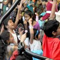 Children raised their hands in hopes of receiving their own magic wand from “Jack the Magician” duri...