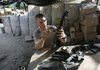 Staff Sgt. Cristopher Davis of Pensacola, Fla., cleans his M4 assault rifle before going out on patrol near Camp Florida in eastern Afghanistan in this September 2006 photo.