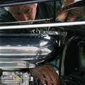 Lynn Brenneman of Bentonville looks under the hood of a 1939 Chevy sedan owned by Bob White of Bento...