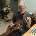 Jack Williams, a nationally known folk musician and singer-songwriter, plays his guitar in his home ...