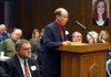 Superintendent Curtis Turner Jr. of the Murfreesboro School District addresses the Arkansas Board of Education on Monday while Hartford School District Superintendent D. Chris Rink watches.