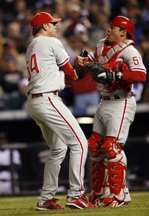 Philadelphia Phillies relief pitcher Brad Lidge celebrates with catcher Carlos Ruiz after Lidge retired Colorado’s Troy Tulowitzki for the final out of the Phillies’ 5-4 victory Monday.