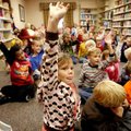 Destini Parrish (center), 6, raises her hand to be picked for a game at the Farmington Public Librar...