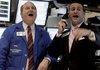 Traders on the floor of the New York Stock Exchange watch the Dow cross the 10,000 mark Wednesday.