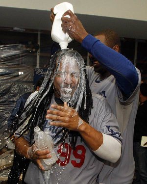 Manny Ramirez of the Los Angeles Dodgers is doused by Guillermo Mota on Saturday. The prospect of a Freeway World Series between the Dodgers and the Los Angeles Angels remains.