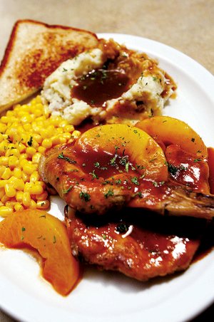 Pork Chops and Peaches are among the surprises on the
entree list at Khalil’s Pub & Grill on Shackleford Road.