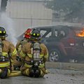 Rogers firefighters concentrate water on flames Thursday morning after Mary Erwin, 38, of Bella Vist...