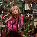 Lori Deaton of Bentonville browses garden and yard art Wednesday in the Kris Craft booth at the Span...