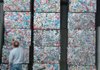 Washington County Justice of the Peace Steve Zega looks at stacks of aluminum cans Wednesday during a tour of Fayetteville’s Solid Waste and Recycling Facility. Elected officials from Benton, Madison and Washington counties toured a variety of solid waste facilities to exchange ideas.