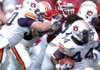 Arkansas senior defensive tackle Malcolm Sheppard tries to fend off the block of Auburn offensive lineman Ryan Pugh (50) as he tries to reach running back Ben Tate (44) Razorbacks played Auburn Saturday Oct. 10 at Razorback Stadium in Fayetteville. The Hogs won 44-23. 