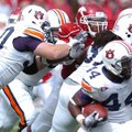 Arkansas senior defensive tackle Malcolm Sheppard tries to fend off the block of Auburn offensive li...