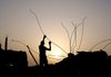 A Palestinian man salvages building material Friday from a house destroyed in Israel’s December-January offensive in Jebaliya in northern Gaza.
