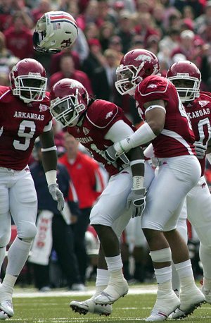 Auburn running back Mario Fannin found out what kind of player Arkansas’ Jerico Nelson (center) is after taking a head-on shot and locking helmets in the Razorbacks’ 44-23 victory Saturday. Now Arkansas’ main problem is keeping Nelson fresh for the positions he plays.