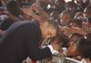 Obama leans in for a moment amid the eager children. Obama told the them that the money and attention that went to rebuilding their campus after Hurricane Katrina had turned it into “a school that is doing much better than it ever was doing before the storm.”