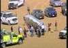Would-be rescuers stand around the downed balloon Thursday in a field near Fort Collins, Colo.