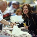 Wendy Pickering of Bentonville smiles Thursday as Ward Shannon of Shannon’s Woven Handcrafts explain...