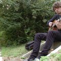 Derek Harvey plays his acoustic guitar on a set of stairs off South Hill Avenue near West Stone Stre...