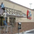 Paul Ashby, bottom, and Ronnie Ramsdell, both with Bayyari Construction Inc., install awnings at the...
