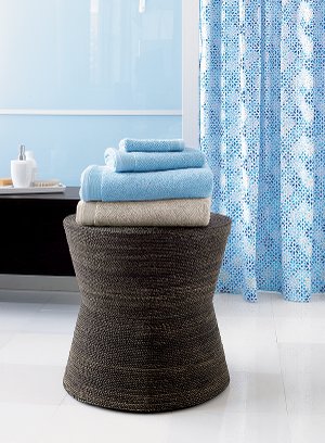 Holding towels in the bathroom is just one use for this stylish piece with an
hourglass figure. Woven of abaca on a powder-coated metal stand reinforced
with plywood for interior stability, its natural variegated tones complement a
variety of furniture finishes. The versatile piece can be used as a bathroom or
vanity stool, nightstand, end table or ottoman and sells for $119 from Crate
and Barrel.