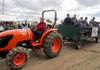 Bentonville Kiwanis volunteer Waltina Hanna towed trailers full of shoppers back and forth from the parking lot to the Bella Vista Arts and Crafts Festival on Friday.

