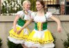 Colleen Rooney, left, and Monica Seiler danced the Pennsylvania Polka with other members of Ballet Westside to start the Third-Friday Twilight Walk Octoberfest in downtown Rogers on Friday night.