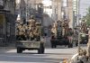 Pakistani troops prepare to leave on patrol Saturday to enforce a curfew in Bannu, a town on the edge of the Waziristan area.