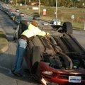 Cyclone Cox, with Greenland Wrecker Service, hooks up chains to a Dodge Avenger Friday after a two-c...
