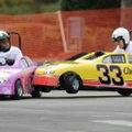 Edosa Aibangbee, left, drives the Big Brothers, Big Sisters of Northwest Arkansas car as Cheerios dr...