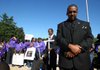 The Rev. Kurbe Newsom and others bow their heads during an opening prayer for Sunday afternoon’s Enough Is Enough: Stop the Violence rally on the steps of the state Capitol.