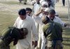 Pakistani soldiers check people who fled from fighting in South Waziristan as they arrive Monday in the town of Dera Ismail Khan, Pakistan.