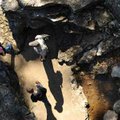 Brad Fike of Dallas, top right, explores the spillway at Lake Fayetteville on Sunday with his two ch...