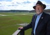 Ray Boudreaux, director of the Fayetteville Executive Airport, stands on the catwalk outside the airport tower Friday in Fayetteville. In his time as director, Boudreaux has helped build several new hangars at the airport and strives to continue improvements to the facilities and numbers of flights in and out of Drake Field.

