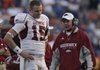 Arkansas quarterback Ryan Mallet talks with coach Bobby Petrino during the third quarter of the Razorbacks game in Florida.