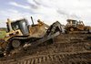 A pair of Caterpillar D6 bulldozers work on construction of a coal loading facility in Newcastle, Australia. 