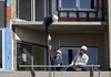 In this Oct. 5, 2009 photo, a worker is handed a tool while working on a large condominium project in the Ballard neighborhood of Seattle. Construction of new homes edged up slightly in September, helped by a rebound in single-family construction.