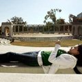 University of Arkansas freshman Sara Osuna of Springdale listens to her digital music player while r...