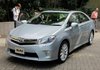 Journalists view the Toyota Motor Corp's hybrid sedan "Sai" during the news conference in Tokyo.