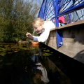 Kali Adams, 9, a fourth-grader at Lee Elementary in Springdale, leans under a bridge railing Tuesday...