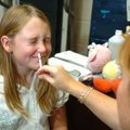 Shyanne Walden, 10, reacts after nurse Shelley Hollingsworth gives her the H1N1 mist vaccine Tuesday...