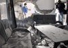 Journalists examine the rubble Tuesday after suicide bombings at International Islamic University in Islamabad, Pakistan. 