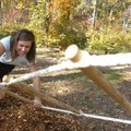 Fayetteville High School junior Caroline Bauman attempts to crawl across a rope course Tuesday durin...