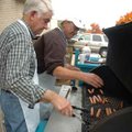 Bill Kisor, left, and Delano Cotton cook hot dogs Wednesday outside the University Baptist Church in...