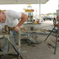 E-Z Mart maintenance workers Jesse Willis, left, and Kesten Holcomb begin to replace old gas dispens...