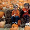 Will Dalton, 4, and his sister Elizabeth Dalton, 7, of Bentonville rest in the pumpkin patch outside...