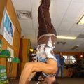 Jonathan Gibbs, community organizer for 1Sky Arkansas, stands on his head Thursday at Nature’s Water...