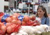 A customer shops for tomatoes at the Sam’s Club warehouse in Bentonville in June.